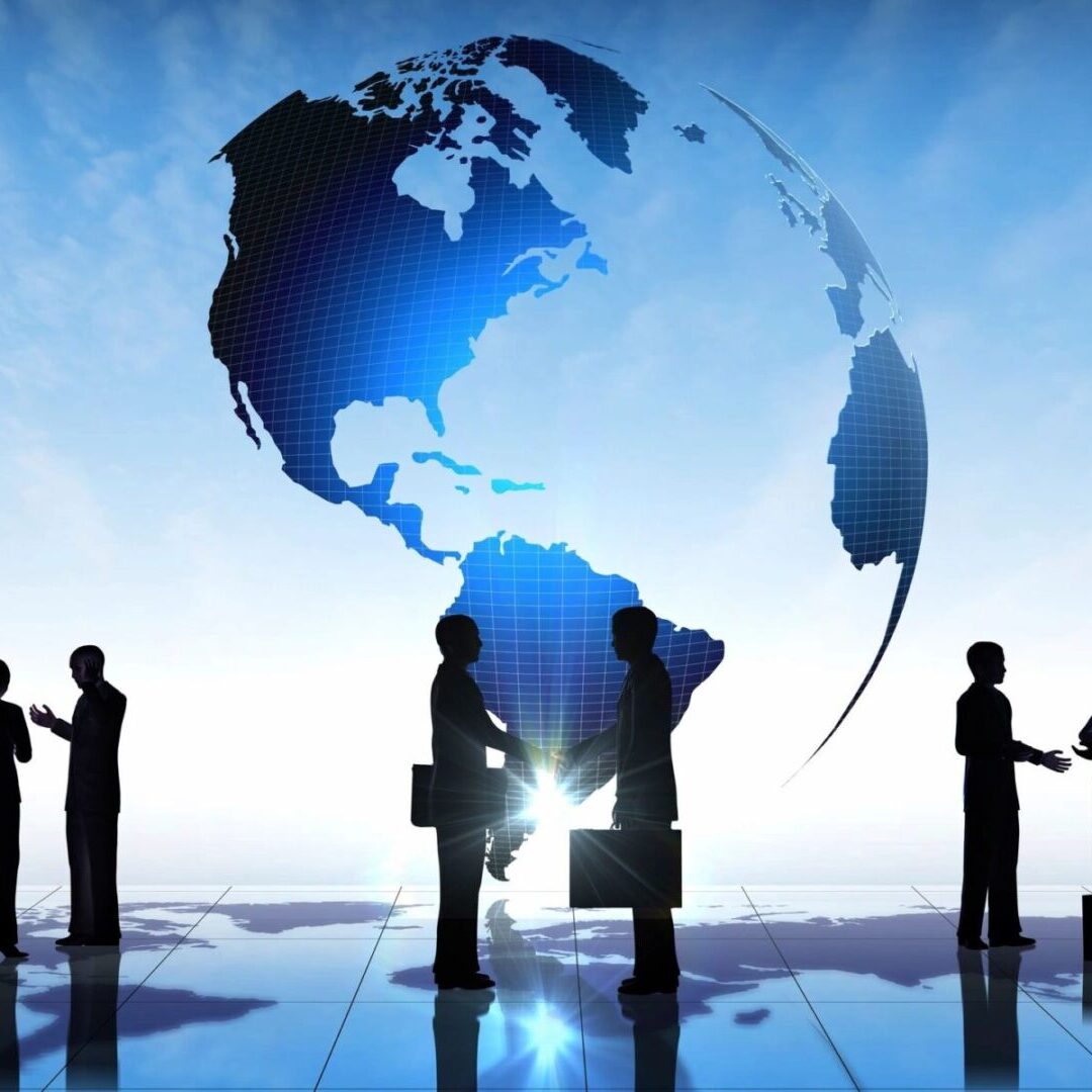 A group of people standing in front of an earth globe.